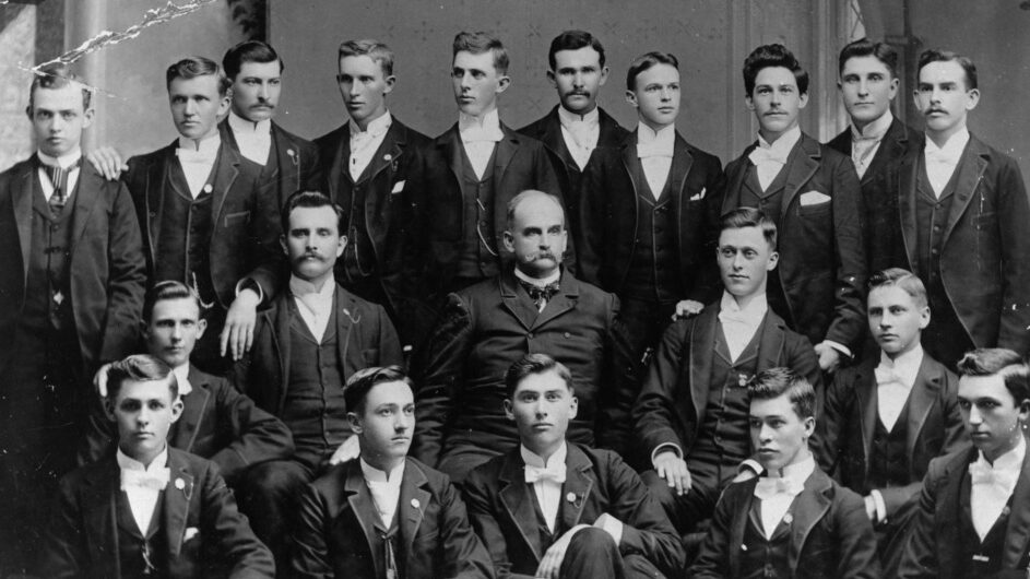 President Alexander Q. Holladay and the first graduating class sit for a portrait, 1893.